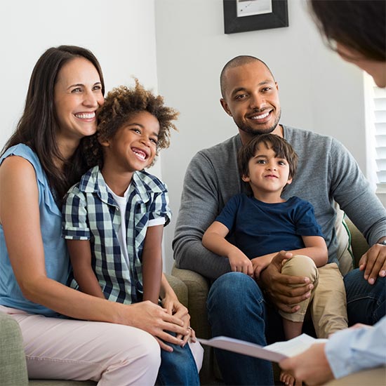 Mixed couple in family therapy session with their children
