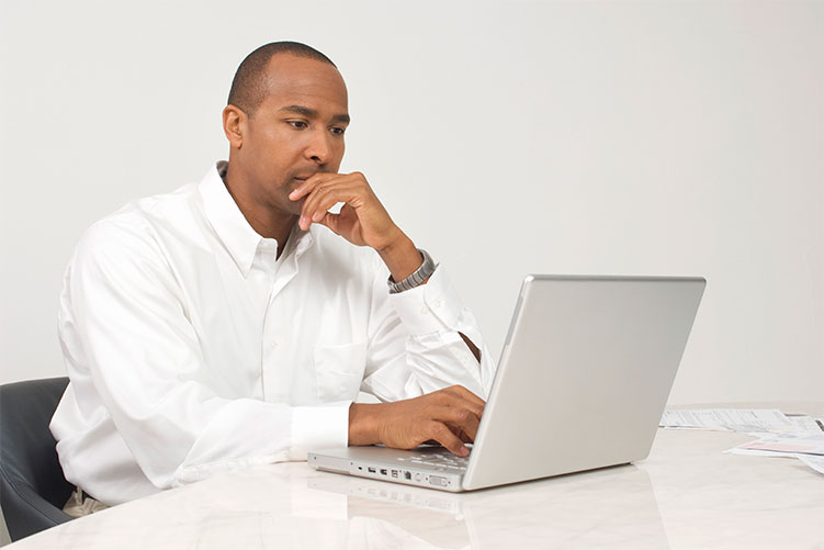 Middle aged African American man having individual therapy session on his computer in Ventura County